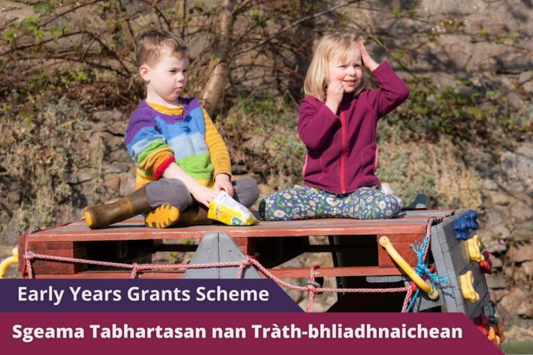 Picture: A young boy and girl sitting on top of a climbing frame in a grassy outdoor space. Text reads 'Gaelic Early Years Grants Scheme'.