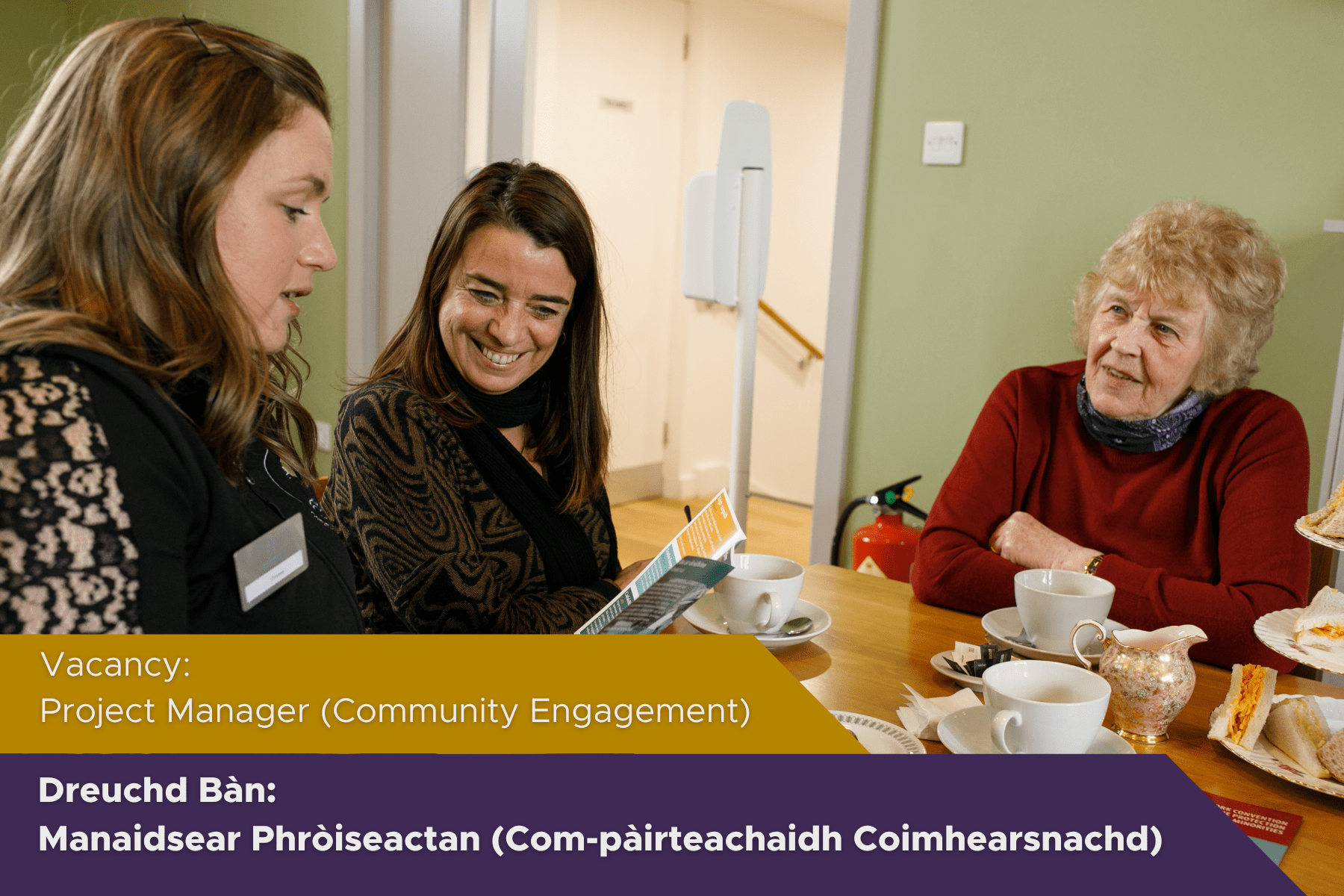 Picture: Three people having a conversation in a community cafe. Text reads "Vacancy: Project Manage (Community Engagement)"